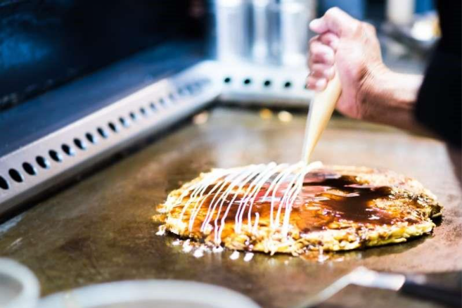 A person putting a pastry on a pancake

AI-generated content may be incorrect.